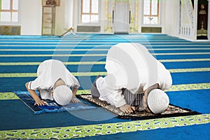 Devout family is prostration in the mosque photo