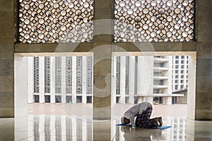 Devout man doing Salat on the Istiqlal mosque