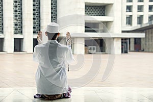 Devout man prays to the Allah in the mosque