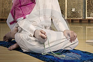 Devout muslim man dhikr in the mosque photo