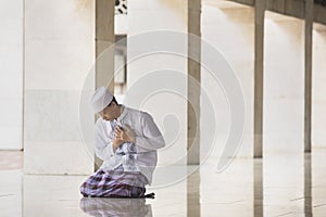 Devout Muslim man looks sad in the mosque