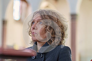 Devout religious woman praying in a church