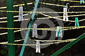 Dew drops in the morning on the clamps, webs and ropes of the green stand.