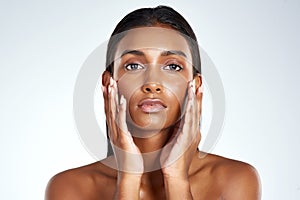 Dewy skin is the hallmark of healthy skin. Studio shot of a beautiful young woman posing against a light background.