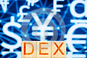 Dex. wooden cubes with the inscription dex on the background of icons of currencies of different countries.