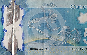 Dextre and canadarm2 on Canada 5 Dollars 2013 Polymer Banknote fragment photo