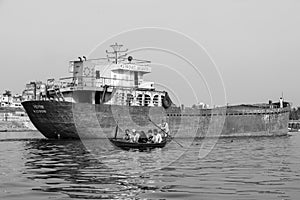 Dhaka, Bangladesh, February 24 2017: Wooden taxi boat with passengers on the river in Dhaka
