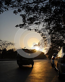 Dhaka, Bangladesh: Silhouette of an auto rickshaw at sunset