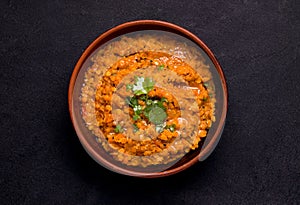 Dhal Indian soup of red lentils on a black background. Traditional cuisine