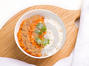 Dhal Indian vegetarian red lentil bean soup in Minsk on a wooden board