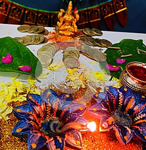 Dhanteras Diwali Pooja celebrating with lit diyas