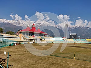 Dharamshala cricket stadium under snow clad mountains