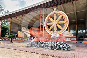 The Dharma Wheel and Reclining or Sleeping Buddha in Wat Phothivihan, Tumpat Kelantan, Malaysia photo