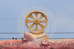 Dharma Wheel on The statue of Wood log, The entrance to the temp