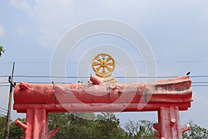 Dharma Wheel on The statue of Wood log, The entrance to the temp