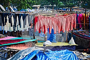 Dhobi Ghat is an open air laundromat lavoir in Mumbai, India with laundry drying on ropes