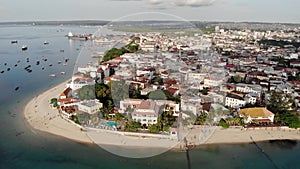 Dhow boats and Stone Town city at Unguja Zanzibar island in Tanzania. Indian ocean aerial view.