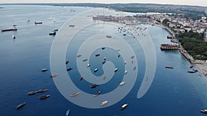 Dhow boats and Stone Town city at Unguja Zanzibar island in Tanzania. Indian ocean aerial view.