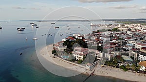 Dhow boats and Stone Town city at Unguja Zanzibar island in Tanzania. Indian ocean aerial view.