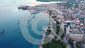 Dhow boats and Stone Town city at Unguja Zanzibar island in Tanzania. Indian ocean aerial view.