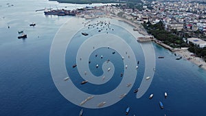 Dhow boats and Stone Town city at Unguja Zanzibar island in Tanzania. Indian ocean aerial view.