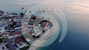 Dhow boats and Stone Town city at Unguja Zanzibar island in Tanzania. Indian ocean aerial view.