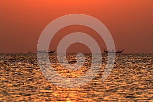 Dhow, traditional boat sailing in sea for fishing during sunset