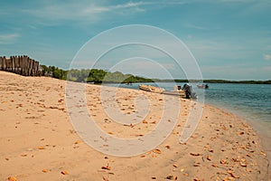 Dhows and boats moored at shore against buildings in Manda Beach, Lamu Island, Kenya