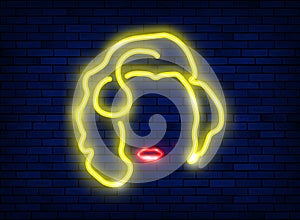 Neon silhouette of a beautiful sexy blonde girl with red lips. Lighted sign of a diva woman with a minimalist style. Night bright photo