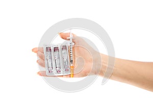Diabetes concept. Hand with syringe injector and insulin vials