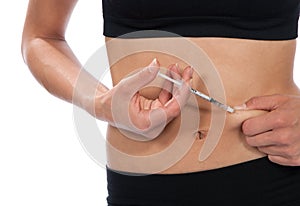 Diabetes insulin injection by syringe with dose of medicine abdo
