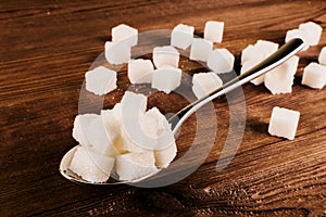 Diabetes. A lot of sugar cubes in spoon