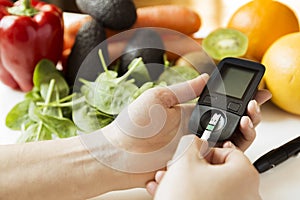 Diabetes monitor, diet and healthy food eating nutritional concept with clean fruits and vegetables with diabetic measuring tool