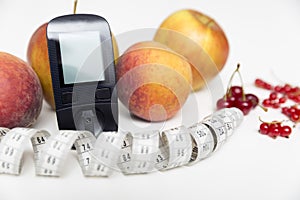Diabetes monitor, diet and healthy food eating nutritional concept with clean fruits with diabetic measuring tool kit ans