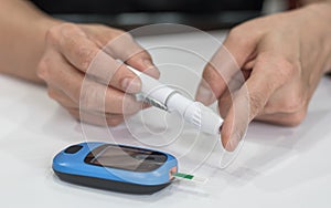 Diabetes monitoring with blood sugar test, glocuse measurement on aged woman patient fingertip for analyzing insulin-deficient