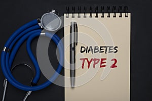 Diabetes type 2 inscription on paper of notebook on black