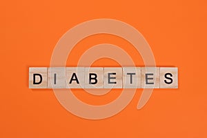 Diabetes word made from wooden letters on orange background