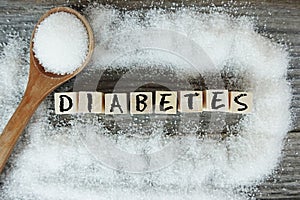 Diabetes word on wooden letters with crystalized white sugar as frame
