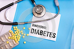 Diabetes word written on medical blue folder with patient files