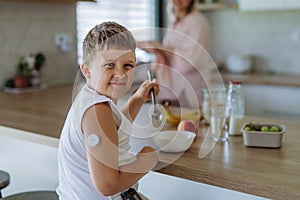 Diabetic boy with a continuous glucose monitor is careful with his diet.