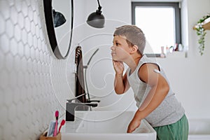 The diabetic boy getting ready in the morning, while wearing a continuous glucose monitoring sensor on his arm.