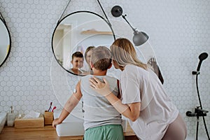 The diabetic boy and his mom getting ready in the morning, while wearing a continuous glucose monitoring sensor on his