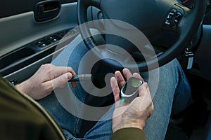 Diabetic man checking blood sugar level at car. Diabetes concept