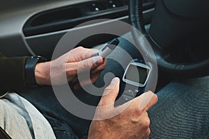 Diabetic man checking blood sugar level, closeup. Diabetes concept