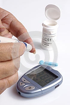 A diabetic testing her glucose level photo