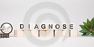 DIAGNOSE word made with wooden blocks concept