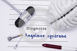 Diagnosis of Angelman syndrome. Neurological hammer and brain figure lie on a medical paper form with a heading diagnosis of Ange