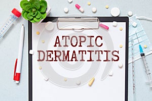 The diagnosis Atopic Dermatitis written on a clipboard photo