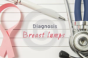 Diagnosis Breast Lumps. Pink ribbon as symbol of struggle with cancer and stethoscope lying on medical form with text labels Diagn
