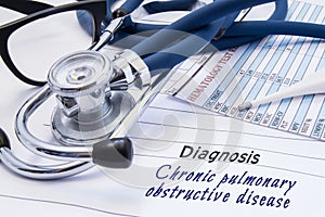 Diagnosis of Chronic pulmonary obstructive disease COPD. On doctors table lies paper with title Chronic pulmonary obstructive di